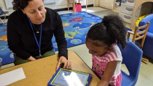 Josey Redinger, NC Pre-K teacher at Central Davie preschool watches as pre-k student Zakoiya Summers works with Cognitive ToyBox