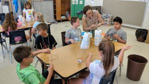 Julie Marklin works with students during an art session at 2019 Read to Achieve Camp