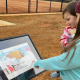 Kellie and Sirena read “A Snowy Day”, the winter book on the story walk trail at the Davie County Community Park