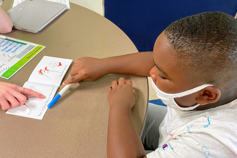 A student at Niner University Elementary School SRC practices reading during a Sound Partners lesson.
